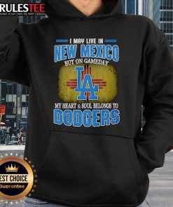Person wearing a Dodgers hoodie in New Mexico, showcasing team spirit on game day with a vibrant backdrop.