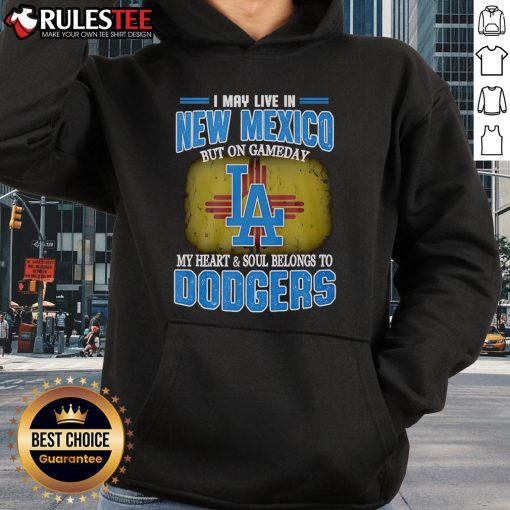 Person wearing a Dodgers hoodie in New Mexico, showcasing team spirit on game day with a vibrant backdrop.