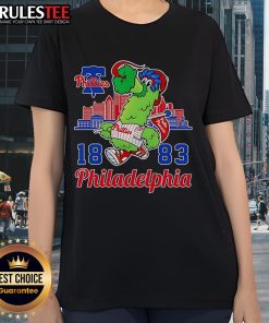 Alt Text: Awesome Phillie Phanatic mascot with Philadelphia skyline on a ladies tee, perfect for Phillies fans.