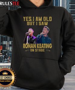 Person wearing 'Awesome Yes I Am Old' hoodie at a Ronan Keating concert, enjoying the live performance on stage.