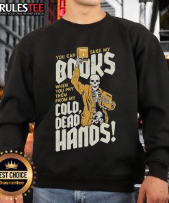 Skeleton sweatshirt featuring the quote 'You can take my books when you pry them from my cold dead hands' in bold letters.
