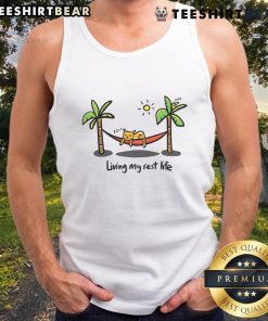 Alt Text: Cute cat wearing a tank top that says 'Living My Rest Life,' showcasing its playful personality and adorable demeanor.