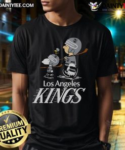 Cute Los Angeles Kings Snoopy and Charlie Brown T-shirt featuring playful graphics of the beloved characters in team colors.