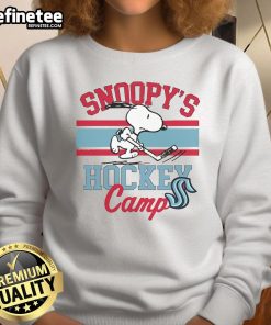 Alt Text: Cute Snoopy in a Seattle Kraken sweatshirt at Snoopy's Hockey Camp, celebrating NHL teams with playful charm.