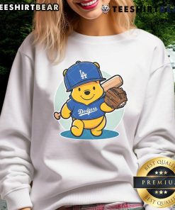 Alt Text: Adorable Winnie the Pooh sweatshirt featuring LA Dodgers logo, perfect for baseball fans and cozy wear.
