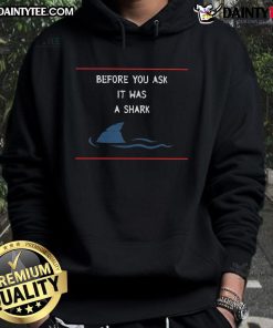 Person wearing a funny shark hoodie, smiling at the camera, showcasing a playful design and vibrant colors.