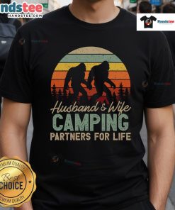Couple wearing 'Good Bigfoot Camping Husband And Wife Partners For Life' T-Shirt, showcasing their love for adventure and Bigfoot.