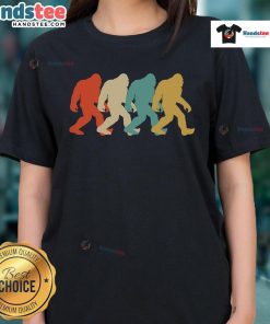 Retro pop art silhouette of Bigfoot on a ladies tee, showcasing a stylish Sasquatch design for fans of cryptids.