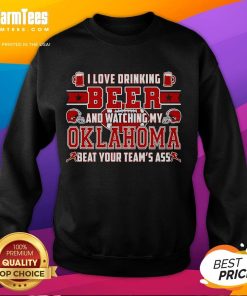 Cozy sweatshirt featuring 'I Love Drinking Beer And Watching My Oklahoma Beat Your Team's Ass' for sports fans.