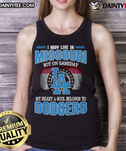 Alt Text: Woman wearing a Dodgers tank top, expressing love for the team on game day in Missouri.