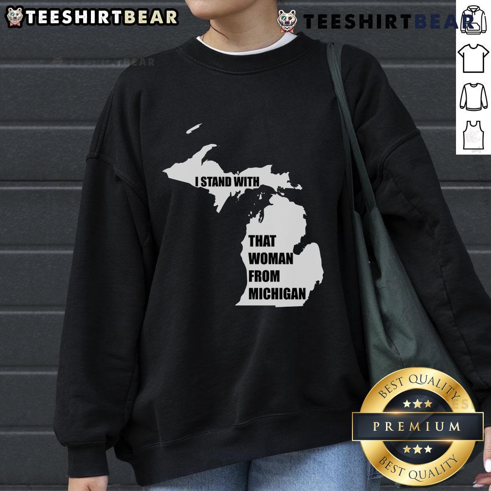 Good I Stand With That Woman From Michigan Sweatshirt Good I Stand With That Woman From Michigan sweatshirt displayed on a hanger, showcasing its vibrant design and colors.