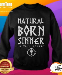 Alt Text: Model wearing Good In This Moment Natural Born Sinner sweatshirt in a cozy urban setting, showcasing stylish streetwear.