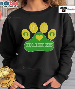 Dog wearing Oregon Ducks sweatshirt with 'Good Paw' design, perfect for pet lovers and sports fans.