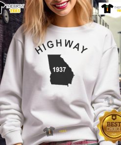 Alt Text: Good Tyrus wearing a vintage 1937 Georgia sweatshirt on the highway, showcasing retro style and nostalgia.