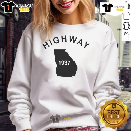 Alt Text: Good Tyrus wearing a vintage 1937 Georgia sweatshirt on the highway, showcasing retro style and nostalgia.