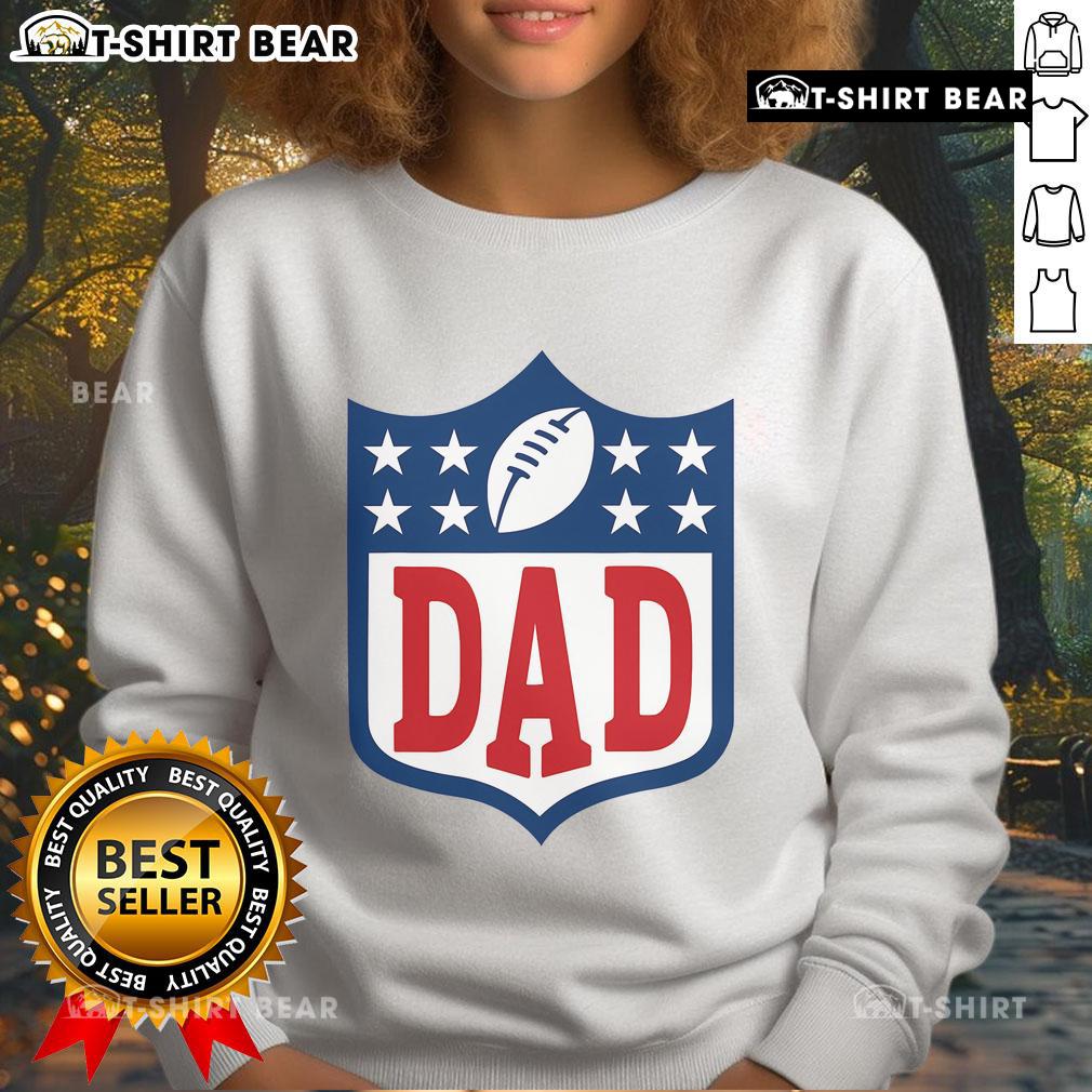 Happy Dad American Football Sweatshirt Happy dad wearing an American football sweatshirt, smiling in a park, showcasing team spirit and family fun.