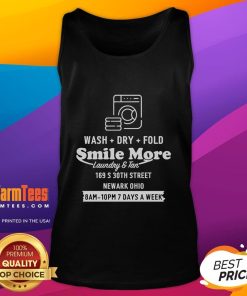 Happy Roman Atwood in a 'Just Methin Around' tank top, smiling while doing laundry in Newark, Ohio.