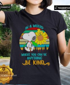 Happy Snoopy with sunflowers on a retro ladies tee, showcasing the message 'In a world where you can be anything, be kind'.