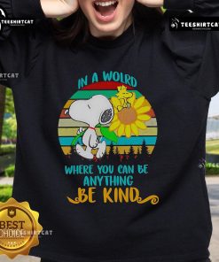 Happy Snoopy with sunflowers on a retro sweatshirt featuring 'Be Kind' quote, perfect for casual wear and dog lovers.