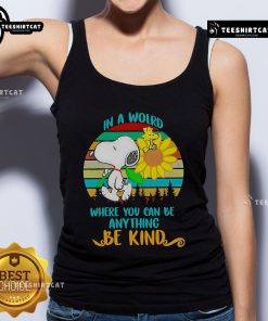 Alt Text: Happy Snoopy with sunflowers on a retro tank top, featuring the quote In a world where you can be anything, be kind.