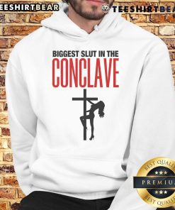 Hot Biggest Slut In The Conclave Hoodie worn by a model, showcasing trendy streetwear style and bold graphic design.
