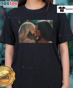 Sabrina Carpenter and Jenna Ortega share a kiss in a stylish 'Kiss and Murder' ladies tee, showcasing their vibrant fashion.