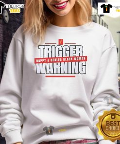 Alt Text: Happy Black woman wearing a Hot Trigger Warning sweatshirt, showcasing confidence and a healed spirit.
