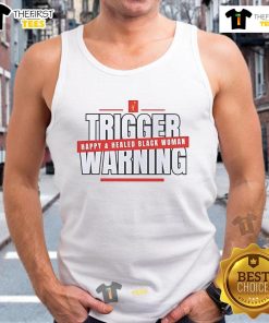 Alt Text: Happy and healed Black woman wearing a tank top with a 'Hot Trigger Warning' graphic, radiating positivity and strength.