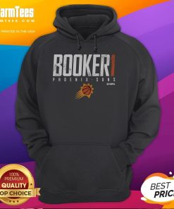 Devin Booker wearing a stylish Phoenix Suns hoodie, showcasing team spirit and fan fashion at a basketball game.