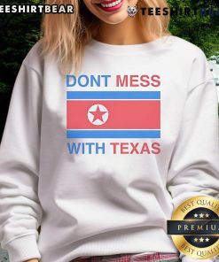 Nice Don't Mess With Texas sweatshirt displayed on a wooden surface, showcasing Texas pride and stylish comfort.