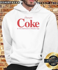 Relaxing in a hoodie, enjoying a Coke in the bathroom, capturing a casual moment of comfort and fun.