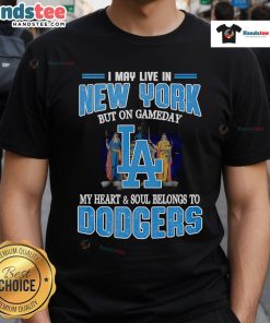 Person wearing 'I May Live In New York But On Gameday My Heart And Soul Belongs To Dodgers' T-shirt at a baseball game.