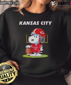 Alt Text: 2025 Nice Kansas City Chiefs X Peanuts Day sweatshirt featuring vibrant graphics and team logo for fans.