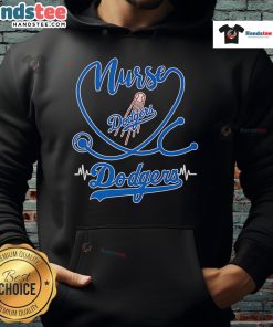Cheerful nurse wearing a Los Angeles Dodgers hoodie, showcasing team spirit and comfort in a vibrant medical setting.