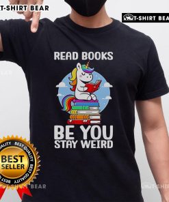 Unicorn T-shirt featuring 'Be You Stay Weird' slogan, perfect for book lovers and unique fashion enthusiasts.