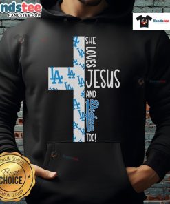 Alt Text: Woman wearing a hoodie that says She Loves Jesus and Los Angeles Dodgers Too, showcasing faith and team spirit.