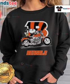 Snoopy and Woodstock riding a motorbike in a Cincinnati Bengals sweatshirt, showcasing playful sports fandom.