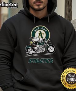 Snoopy and Woodstock riding a motorbike, wearing an Oakland Athletics hoodie, capturing a fun and playful moment.