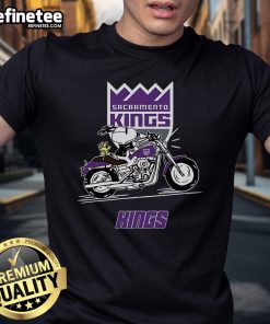 Alt Text: Snoopy and Woodstock riding a motorbike on a Sacramento Kings T-shirt, perfect for fans of the team and Peanuts.