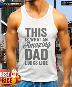 Amazing dad wearing a tank top with 'This Is What An Amazing Dad Looks Like' text, showcasing pride and style.