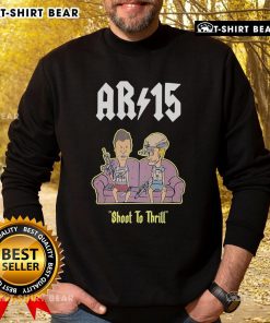 Official Beavis and Butthead AR-15 Shoot to Thrill sweatshirt on a sofa, showcasing fun retro graphic design.
