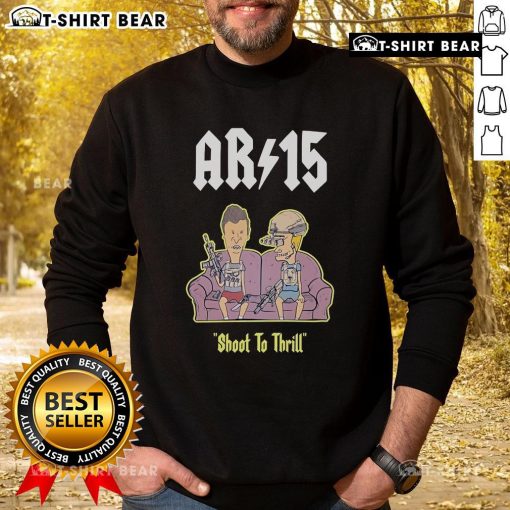 Official Beavis and Butthead AR-15 Shoot to Thrill sweatshirt on a sofa, showcasing fun retro graphic design.