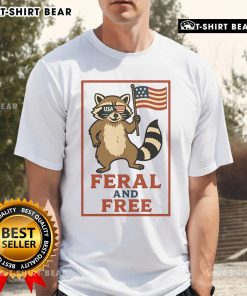Official Feral And Free Raccoon America Flag T-Shirt featuring a raccoon graphic on a patriotic flag design.