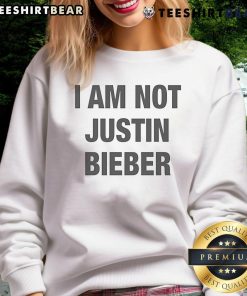 Official I Am Not Justin Bieber Sweatshirt featuring bold typography on a stylish black background.
