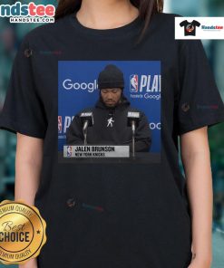 Alt Text: Official Jalen Brunson press conference ladies tee featuring team logo and stylish design for fans.