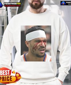 Josh Hart takes an elbow to the face in a stylish sweatshirt, showcasing his resilience on the basketball court.
