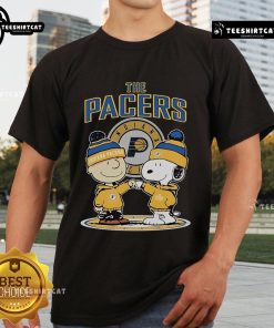 Alt Text: Official Snoopy and Charlie Brown The Peanuts fan T-shirt featuring Indiana Pacers logo and colorful design.