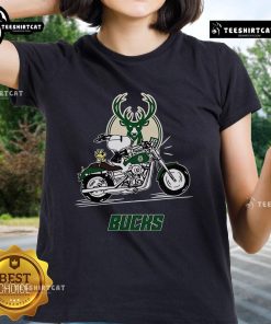 Official Snoopy and Woodstock driving motorbike on Milwaukee Bucks ladies tee, perfect for fans and fashion lovers.