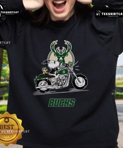 Alt Text: Snoopy and Woodstock riding a motorbike on a Milwaukee Bucks sweatshirt, showcasing a fun and vibrant design.