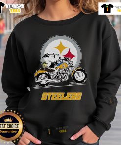 Snoopy and Woodstock in Pittsburgh Steelers sweatshirt riding a motorbike, showcasing team spirit and fun.